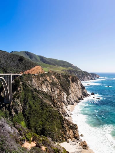 Pacific Coast Highway RV itinerary shown through an image of the bridge in Big Sur, Ca